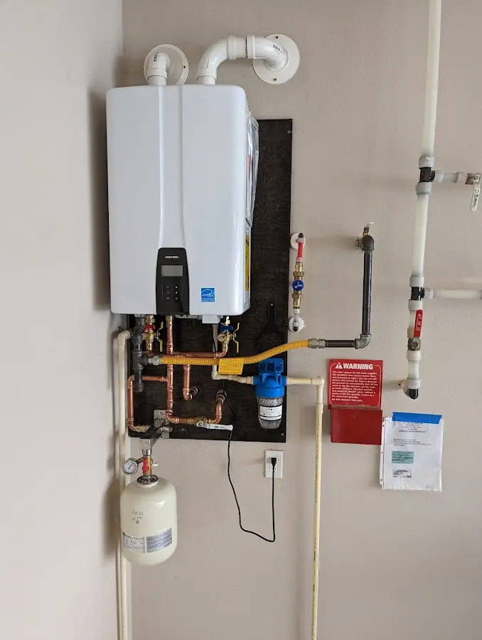 Professional plumber installing copper piping in a Rocky Ford home